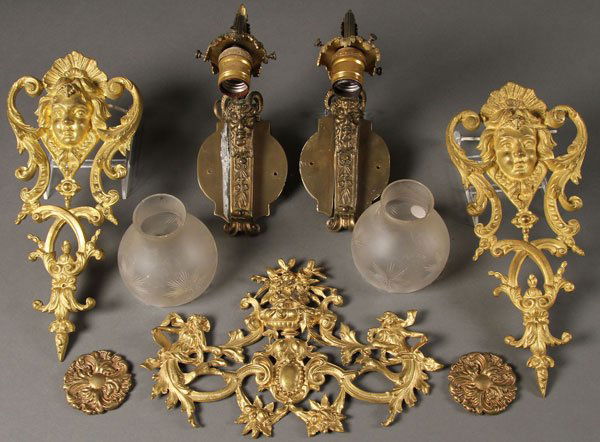 PAIR FRENCH STYLE GILT BRONZE SATYR WALL SCONCES: A PAIR OF FRENCH STYLE GILT BRONZE WALL SCONCES WITH FIGURAL SATYR MASKS AND ETCHED IN FROSTED GLASS SHADES. Together with two gilt bronze ornamental wall plaques with facial masks and an Art Nouveau
