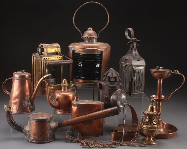 EARLY COPPER AND TIN LIGHTING AND ACCESSORIES: AN EARLY COPPER AND TIN LIGHTING AND ACCESSORIES GROUP, 19TH CENTURY. Comprising a ships starboard lantern, a tin candle lamp, an "Osmeka" carbide lamp, a tin skaters lamp, a tall handled whale oil la
