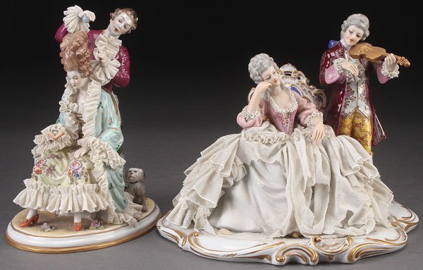 A PAIR OF DRESDEN STYLE PORCELAIN FIGURAL GROUPS,: A PAIR OF DRESDEN STYLE PORCELAIN FIGURAL GROUPS, 20TH CENTURY. Comprising an Oldest Volkstedt seated woman with hairdresser, and a figural group of a seated woman with man playing violin with crown N