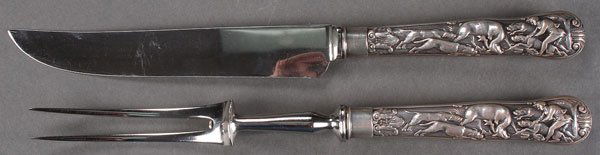 STAG HUNT SILVER CARVING SET, AFTER PAUL STORR: STAG HUNT PATTERN SILVER CARVING SET, AFTER PAUL STORR, PROBABLY EARLY 20TH CENTURY. With spurious hallmarks for London 1816, the knife marked "Made in Sheffield England, Nottershaw and Row." Together