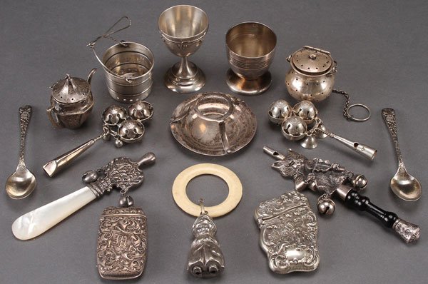 15 PC STERLING AND SILVER PLATE NOVELTY GROUP: A 15 PIECE STERLING AND SILVER PLATE NOVELTY GROUP, 19TH AND 20TH CENTURY. Comprising three sterling tea balls, two sterling egg cups, two sterling Victorian match safes, a sterling tea ball rest, a s
