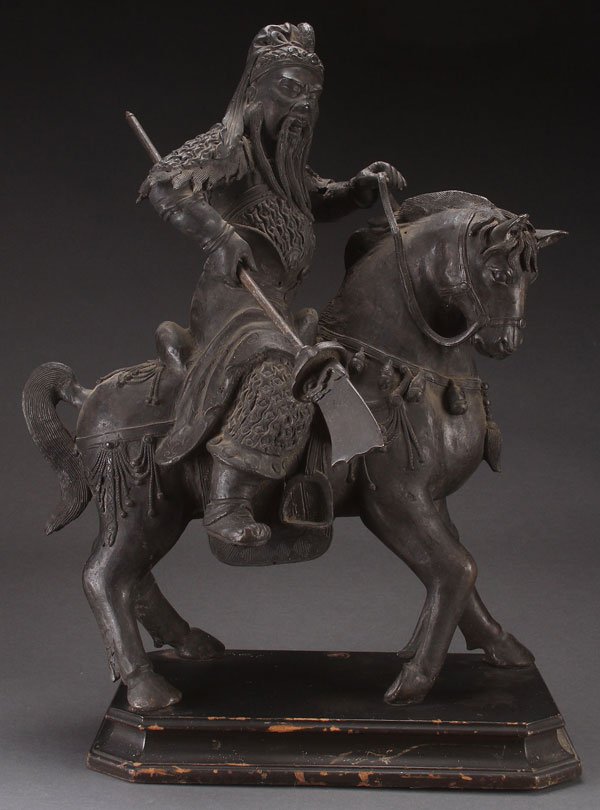 CHINESE BRONZE FIGURE HORSE MOUNTED TANG STYLE WARRIOR: A CHINESE BRONZE FIGURE OF A HORSE MOUNTED TANG STYLE WARRIOR, EARLY 20TH CENTURY. Raised on an ebonized wood plinth. Total height 23 inches (59 cm).