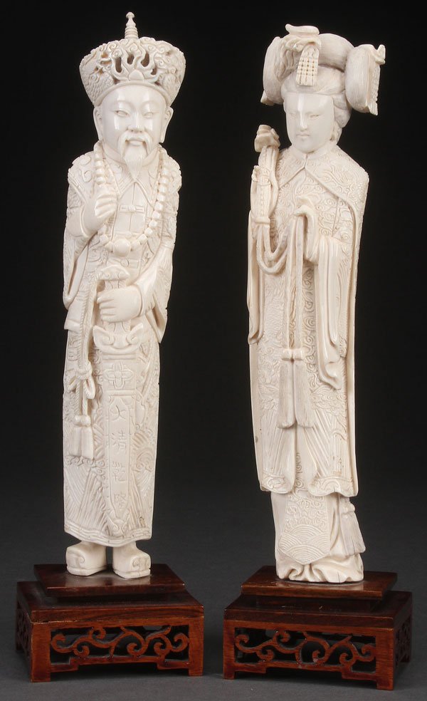CHINESE EXPORT CARVED IVORY EMPEROR AND EMPRESS: A PAIR OF CHINESE EXPORT CARVED IVORY EMPEROR AND EMPRESS FIGURES, PROBABLY LATE QING DYNASTY. Each finely carved in ornate Imperial court robes with accoutrements including a Ruyi scepter and sword. 
