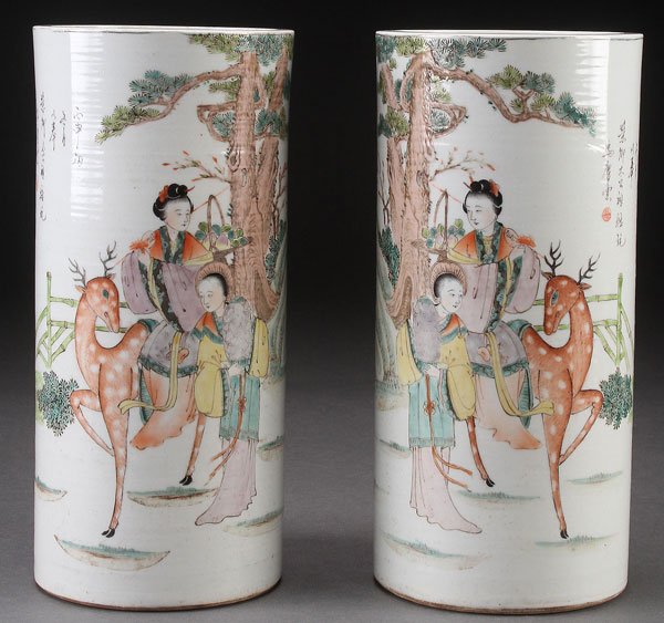 CHINESE FAMILLE ROSE FIGURES AND DEER HAT STANDS: A PAIR OF CHINESE FAMILLE ROSE FIGURES AND DEER PORCELAIN VASES OR HAT STANDS. With calligraphy inscriptions. Height 11 inches (28 cm).