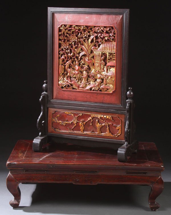 A CHINESE CARVED RED LACQUER AND GILT SCREEN: A CHINESE CARVED RED LACQUER AND GILT SCREEN, EARLY 20TH CENTURY. Carved with figures in a garden setting with pavilion, together with a low alter stand. Screen height 30.75 inches (78 cm).