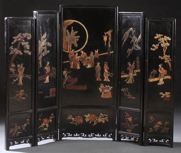 A CHINESE FIVE PANEL FOLDING HARDSTONE SCREEN: A CHINESE FIVE PANEL FOLDING CARVED HARDSTONE SCREEN, 20TH CENTURY. The ebonized panels with applied and carved colored hardstones, depicting figures, florals, and trees. The verso with incised carved