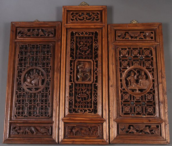 A GROUP OF THREE CARVED AND PIERCED WOOD PANELS,: A GROUP OF THREE CARVED AND PIERCED WOOD PANELS, 20TH CENTURY. With openwork carved floral rosettes surrounding central medallions of figures in deep relief. Largest height 35 inches (89 cm).