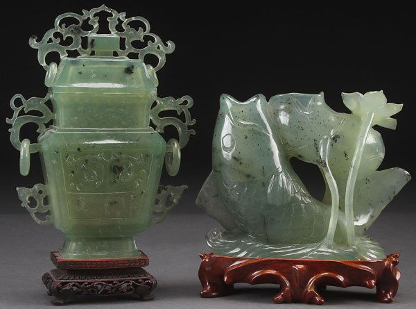 A LARGE CHINESE CARVED HARDSTONE LIDDED URN, 20TH: A LARGE CHINESE CARVED HARDSTONE LIDDED URN, 20TH CENTURY. Of archaic form with reticulated and suspended loose ring handles, raised on a carved hardwood stand. Together with a carved hardstone fish f