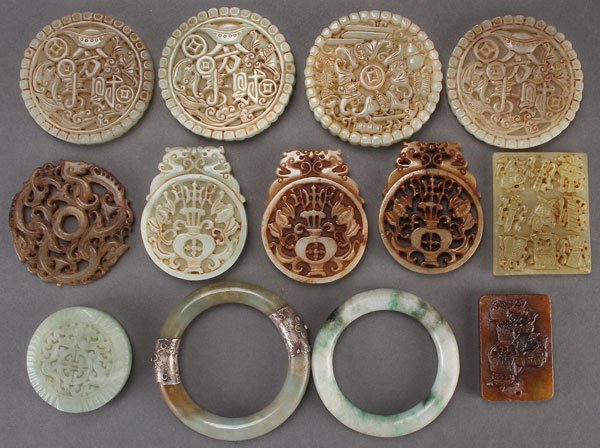 A 13 CHINESE CARVED HARDSTONE MEDALLIONS: A 13 PIECE CHINESE CARVED HARDSTONE MEDALLION GROUP, 20TH CENTURY. Comprising various sized plaques and medallions carved with Buddhist symbols on the obverse and repeated on the reverse, an archaic s