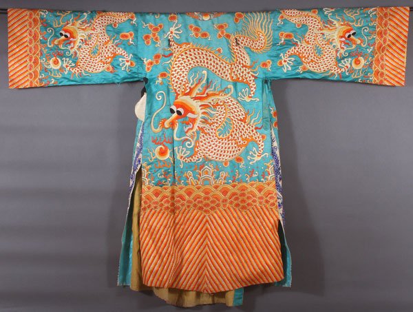 A CHINESE EMBROIDERED SILK COURT ROBE: A CHINESE EMBROIDERED SILK COURT ROBE, LATE 19TH/EARLY 20TH CENTURY. Embroidered with a dragon in red, orange, yellow, and silvered silks on a turquoise ground. Cuff to cuff 81 inches (206 cm), length