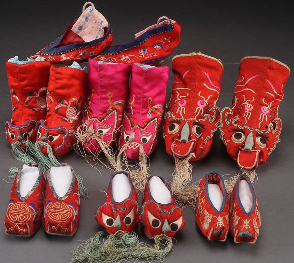 7 PAIRS OF ORIENTAL EMBROIDERED SILK FESTIVAL SHOES: SEVEN PAIRS OF ORIENTAL EMBROIDERED SILK FESTIVAL SHOES/BOOTS, EARLY 20TH CENTURY. Including animal form facial masks. Largest height 6.5 inches (16.5 cm)