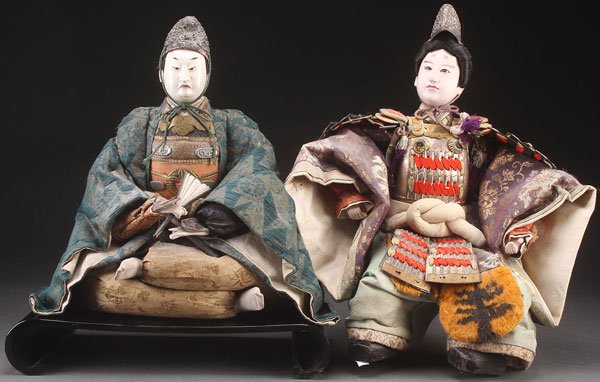 LARGE JAPANESE NINGYO DOLLS, MEIJI PERIOD: A PAIR OF LARGE JAPANESE NINGYO DOLLS, MEIJI PERIOD. Each depicting warrior figures with gofun face and hands, inset glass eyes, and period style clothing. Largest height 18.5 inches (47 cm).