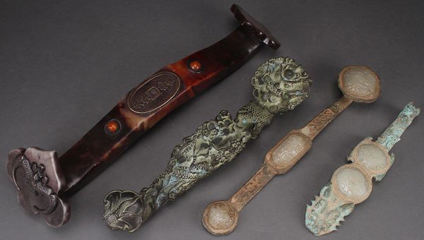 A COLLECTION OF FOUR CHINESE RUYI SCEPTERS: A COLLECTION OF FOUR CHINESE RUYI SCEPTERS, 20TH CENTURY. In various material including bronze and hard stone. Largest length 14.75 inches (37.5 cm).