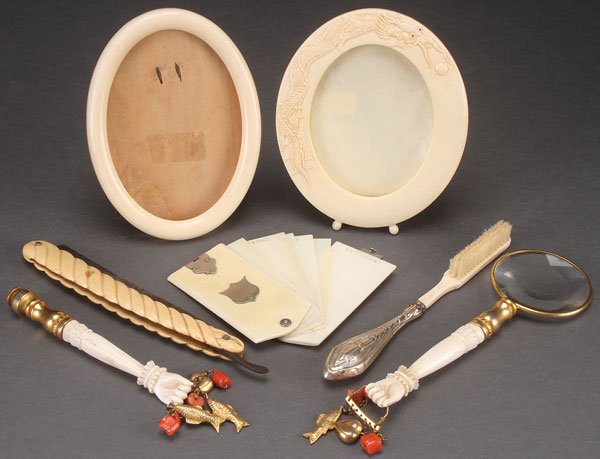 A SEVEN PIECE GROUP OF ORIENTAL CARVED IVORY: A SEVEN PIECE GROUP OF ORIENTAL CARVED IVORY, LATE 19TH CENTURY. Comprising two oval picture frames (one with relief carved dragon), a folding days of the week notebook, a Robeson Cutlery straight raz