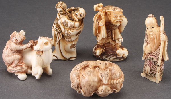 JAPANESE CARVED IVORY NETSUKE AND OKIMONO: A VERY FINE JAPANESE CARVED IVORY NETSUKE AND OKIMONO GROUP, PROBABLY MEIJI PERIOD. Comprising a pair of wrestlers, a figure with barrel and frog, a figure with bamboo and snail, and an okimono of two