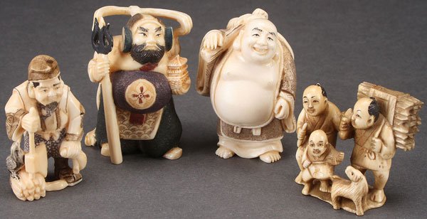 FOUR VERY FINE JAPANESE CARVED IVORY NETSUKES: FOUR VERY FINE JAPANESE CARVED IVORY NETSUKES, PROBABLY MEIJI PERIOD. Comprising a happy traveler, a warlord, a firewood merchant, and a group of four figures. Each with incised signature. The largest