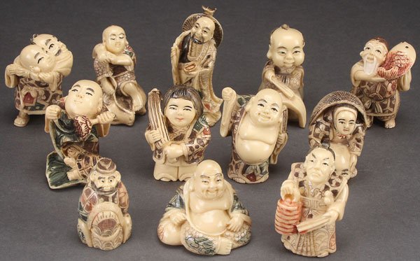 A CASED SET OF 12 CHINESE FAUX IVORY NETSUKES: A CASED SET OF 12 CHINESE FAUX IVORY NETSUKES, 20TH CENTURY. Cast resin with incised and polychrome details. Largest height 2.75 inches (7 cm).