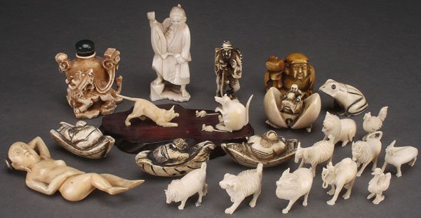 A 23 PIECE GROUP OF ORIENTAL CARVED IVORY FIGURES: A 23 PIECE GROUP OF ANTIQUE ORIENTAL CARVED IVORY FIGURES, CIRCA 1900. Comprising a doctor's lady, dragon snuff bottle, netsukes and an animal menagerie. The largest 7 inches (18 cm).