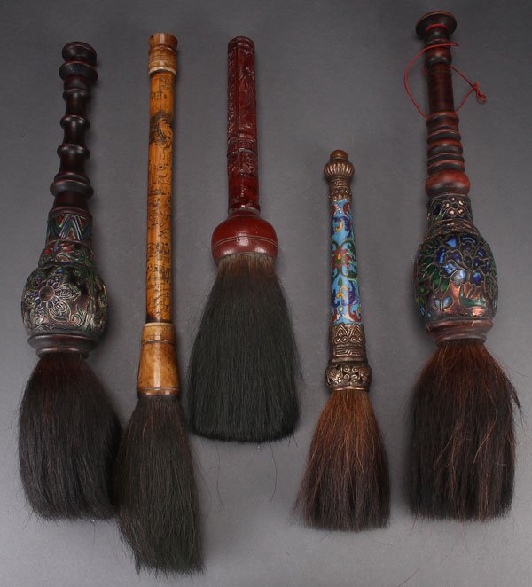 A GROUP OF FIVE LARGE CHINESE CALLIGRAPHY BRUSHES: A GROUP OF FIVE LARGE CHINESE CALLIGRAPHY BRUSHES, 20TH CENTURY. In horse hair with carved wood, bamboo, and cloisonné handles. Largest length 21 inches (53.5 cm).