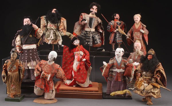 A COLLECTION OF 11 JAPANESE NINGYO DOLLS, EARLY T: A COLLECTION OF 11 JAPANESE NINGYO DOLLS, EARLY TO MID 20TH CENTURY. Depicting various samurai, cultural heroes, and other figures, dressed in period style clothing. Largest height 11 inches (28 cm).