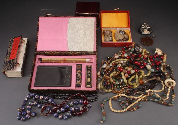 AN ORIENTAL DECORATIVE ART AND JEWELRY GROUP, 20T: AN ORIENTAL DECORATIVE ART AND JEWELRY GROUP, 20TH CENTURY. Comprising cloisonné necklace, various beaded necklaces including carnelian, carved hardstone pendant, mahogany box, a cased Japanese calli