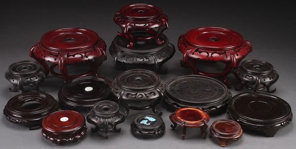 16 CHINESE CARVED HARDWOOD STANDS: A GROUP OF 16 CHINESE CARVED HARDWOOD STANDS, 20TH CENTURY. Including mahogany and ebonized wood. Largest diameter 8.25 inches (21 cm).