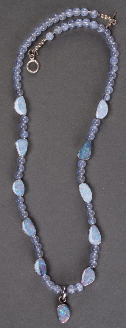 A LADIES CHALCEDONY AND OPAL NECKLACE: A LADIES CHALCEDONY AND OPAL NECKLACE, LATE 20TH CENTURY. Comprising 66 Namibia blue chalcedony 4 mm beads, and 11 Australian opal doublets in sterling silver bezels with a sterling clasp. Total lengt