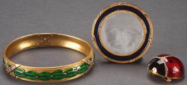 AFTER PETER CARL FABERGE: MUSEUM OF ART JEWELRY: AFTER PETER CARL FABERGE: A METROPOLITAN MUSEUM OF ART JEWELRY GROUP, 20TH CENTURY. Comprising a Lady Bug Pin/Pendant, a Moon Face Pin/Pendant, and an Enameled Leaf Bracelet. The Moon face pin and bra