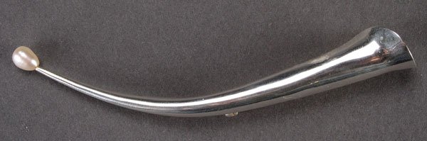 A BETSY FULLER STERLING & PEARL MOUNTED LAPEL VASE: A BETSY FULLER STERLING AND PEARL MOUNTED DESIGNER LAPEL VASE, 20TH CENTURY. Of elongated trumpet form with a natural pearl terminal inscribed “Betsy Fuller” and stamped “sterling”. Length 3.7