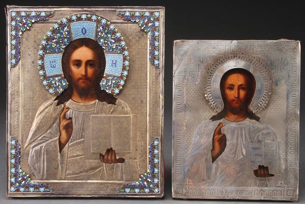 A PAIR OF RUSSIAN ICONS.: A PAIR OF RUSSIAN ICONS. Comprising Christ as the Lord Almighty delivering a blessing and holding an open book of Gospels to John 13:34, overlaid with a silver-gilt machine engraved riza with possibl