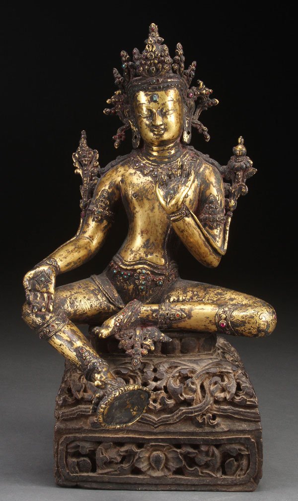 SINO-TIBETAN BRONZE & JEWELED BUDDHIST FIGURE: A SINO-TIBETAN GILT BRONZE AND JEWELED BUDDHIST FIGURE, 19TH/20TH CENTURY. Probably of Indra, depicted in seated form and embellished with numerous faceted paste gemstones. Raised on an associated car