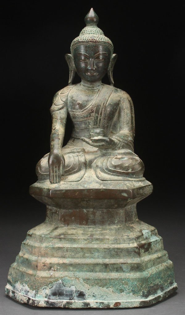A SINO-TIBETAN BRONZE FIGURE OF SAKYAMUNI: A SINO-TIBETAN BRONZE FIGURE OF SAKYAMUNI, PROBABLY 19TH CENTURY, PERHAPS EARLIER. Depicting the seated figure of Buddha atop a stepped throne under a rich verdi-gras oxidized patina with encrustation