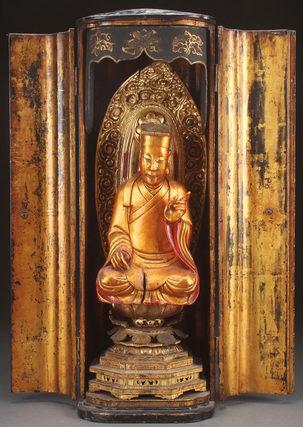 A JAPANESE CARVED GILT WOOD AND LACQUER SHRINE: A JAPANESE CARVED GILT WOOD AND LACQUER ZUSHI (SHRINE), MEIJI PERIOD, PERHAPS EARLIER. Of oval rectangular form, the shaped doors opening to reveal a multi-tiered lotus throne pedestal with flaming ma