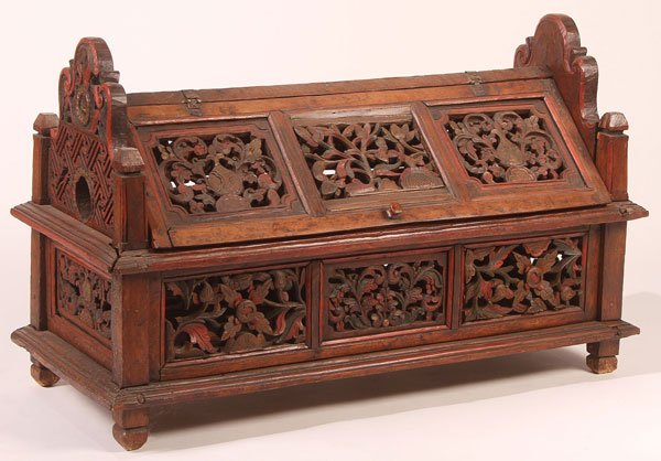 CHINESE CARVED HARDWOOD CHILD'S CRADLE CIRCA 1900: A CHINESE CARVED HARDWOOD CHILD'S CRADLE, CIRCA 1900. With pierced carved wood foliate panel design doors and overall scrolling foliate decoration. Length 37 inches (94 cm).
