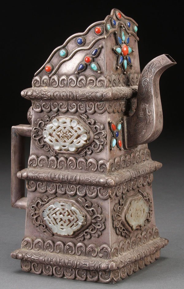 CHINESE MONGOLIAN SILVER AND JADE TEAPOT: A CHINESE MONGOLIAN STYLE JADE MOUNTED SILVER TEAPOT, 20TH CENTURY. Of archaic form with repoussé and chased scroll designs, mounted with five reticulated white jade plaques and various cabochon jewe