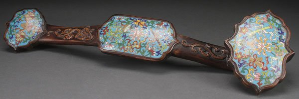A CHINESE CLOISONNÉ AND CARVED WOOD RUYI SCEPTER: A CHINESE CLOISONNÉ AND CARVED WOOD RUYI SCEPTER, PROBABLY 20TH CENTURY. Carved with dragons in relief and inset with three cloisonné plaques decorated with Buddhist symbols, the verso with a carved