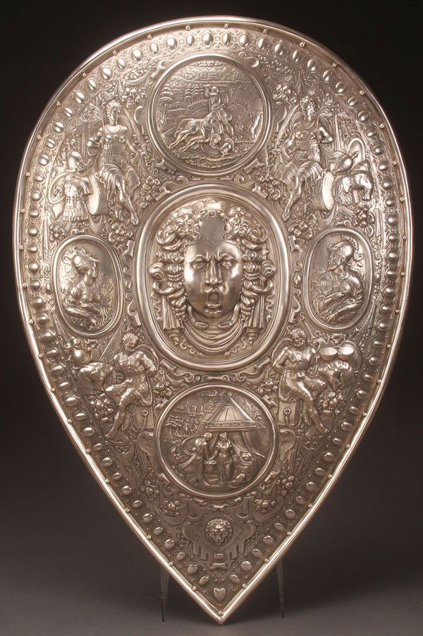 A LARGE AND IMPRESSIVE SILVERED BRONZE SHIELD: A LARGE AND IMPRESSIVE SILVERED BRONZE SHIELD OF FRANCESCO I DE MEDICI, 19TH CENTURY, AFTER THE ORIGINAL BY BENVENUTO CELLINI (ITALIAN 1500-1571). At center of the concave form shield a high relief sc