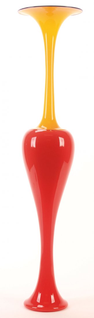 A DANTE MARIONI ART GLASS "GAMBO" VASE, 1998.: A DANTE MARIONI ART GLASS "GAMBO" VASE, 1998. Of elongated baluster form in Chinese red colored glass with applied lemon yellow trumpet form neck and rim with cobalt wrap. The pontil inscribed "Marion