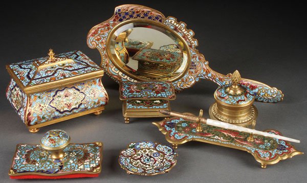 6 PIECE GROUP OF FRENCH CHAMPLEVÉ BRONZE ITEMS: A VERY FINE SIX PIECE GROUP OF FRENCH CHAMPLEVÉ BRONZE DESK ITEMS, CIRCA 1900. Comprising a miniature gilt bronze casket with velour interior, a beveled glass hand mirror, a gilt bronze ink stand wit