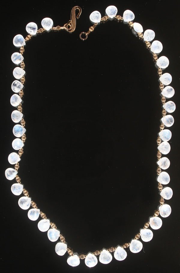 A RAINBOW MOONSTONE NECKLACE, 20TH CENTURY.: A RAINBOW MOONSTONE NECKLACE, 20TH CENTURY. Comprising 42 faceted teardrop shaped moonstone rainbow beads, with alternating fluted gold beads, totaling approximately 72 cts. Length 18 inches (46 cm),