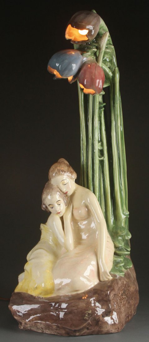 A LARGE WIENER WERKSTATTE FIGURAL CERAMIC LAMP: A LARGE AND IMPRESSIVE WIENER WERKSTATTE FIGURAL CERAMIC TABLE LAMP, CIRCA 1910. Of stylized form depicting two young women in reflective thought, seated on a rockery ground below elongated stems te