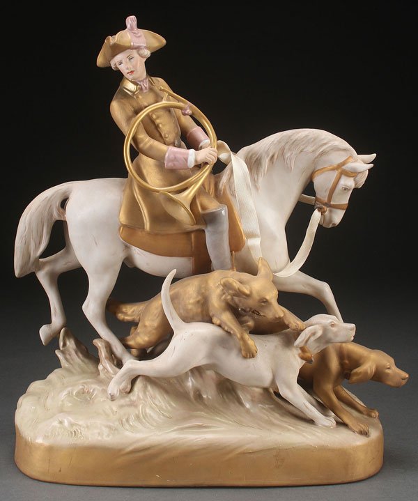A LARGE ROYAL DUX FIGURAL HUNT SCENE GROUPING, EA: A LARGE ROYAL DUX FIGURAL HUNT SCENE GROUPING, EARLY 20TH CENTURY. Modeled as an equestrian figure with horn and three dogs. Height 19 inches (48.5 cm).