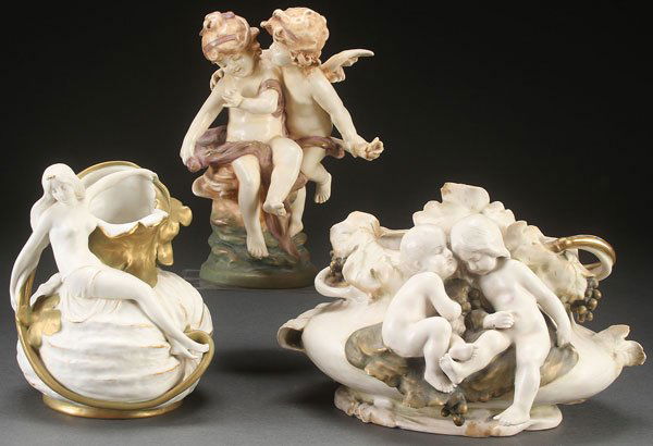 AN AUSTRIAN AND AMPHORA FIGURAL ART POTTERY GROUP: AN AUSTRIAN AND AMPHORA FIGURAL ART POTTERY GROUP, CIRCA 1900. Comprising an Ernst Wahliss Art Nouveau vase depicting a semi nude young woman resting on a melon form, an RSTK handled planter with youn