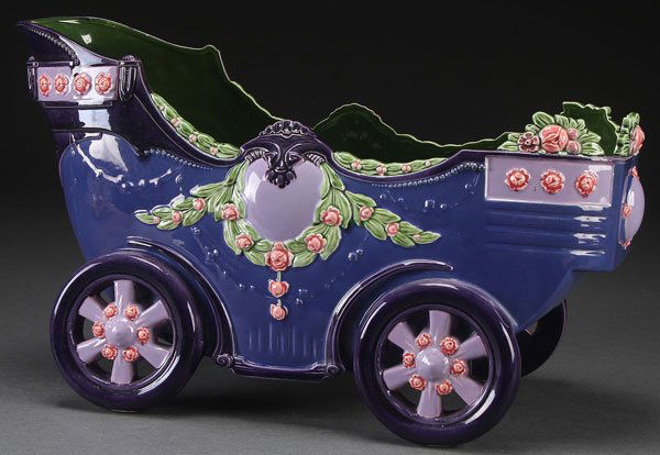 AN ICHWALD CZECH ART POTTERY CARRIAGE FORM PLANTE: AN ICHWALD CZECH ART POTTERY CARRIAGE FORM PLANTER, EARLY 20TH CENTURY Some minor glaze lifting. Length 18.5 inches (47 cm).