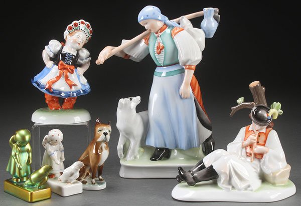 FIVE ZSOLNAY PORCELAIN FIGURES, 20TH CENTURY: FIVE ZSOLNAY PORCELAIN FIGURES, 20TH CENTURY. Including a large figure of a field worker with dog, a reclining flute player, and other figures, together with a Herend figure of a young girl in dress. 