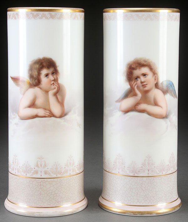 A PAIR OF AHNE SIGNED RAPHAEL CHERUB VASES: A PAIR OF AHNE SIGNED RAPHAEL CHERUB VASES, LATE 19TH CENTURY. Cylindrical form with two hand-painted cherubs after Raphael, signed lower right "Ahne." Height 12.75 inches (32.5 cm).