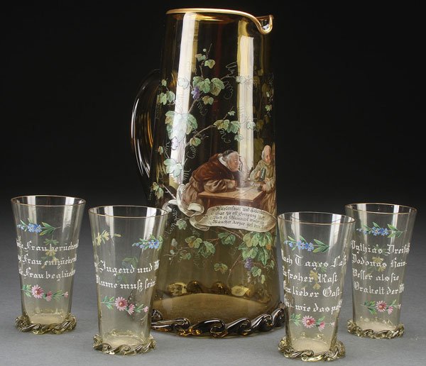 A VERY FINE FRITZ HECKERT ENAMELED BOHEMIAN GLASS: A VERY FINE FRITZ HECKERT ENAMELED BOHEMIAN GLASS BEVERAGE SET, CIRCA 1880. In olive colored glass, finely painted with a scene of monks drinking above a calligraphy inscribed scroll, surrounded by an