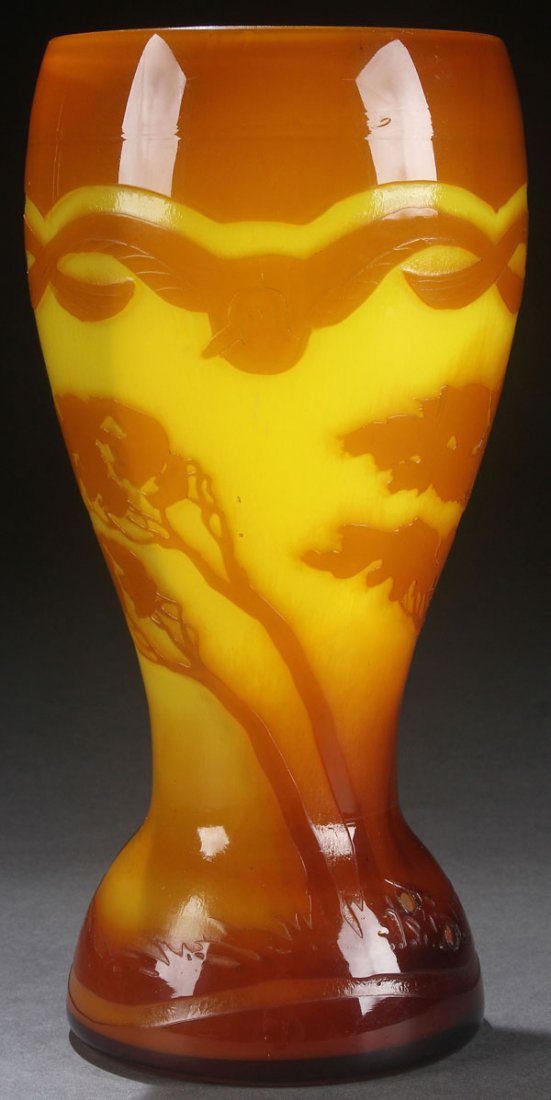 A BOHEMIAN ART DECO CAMEO GLASS VASE, EARLY 20TH: A BOHEMIAN ART DECO CAMEO GLASS VASE, EARLY 20TH CENTURY. In lemon colored semi-translucent glass overlaid with caramel and cut with a design of trees below a shoulder. With overlapping winged birds. 