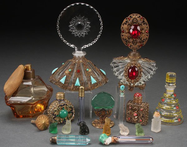 EIGHT CZECH PERFUME BOTTLES, EARLY 20TH CENTURY: EIGHT CZECH PERFUME BOTTLES, EARLY 20TH CENTURY. Of various form including a ruby jeweled and gilt filigree, a cut glass gilt filigree and turquoise mounted vase with large rosette form cut stopper, s