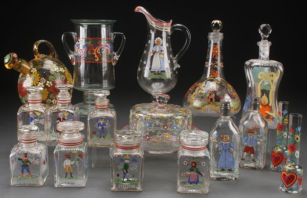 A 16 PIECE GROUP OF CZECH ENAMELED GLASS APOTHYCA: A 16 PIECE GROUP OF CZECH ENAMELED GLASS APOTHYCARY JARS, BOTTLES, AND TABLEWARE, 20TH CENTURY. Mostly in crystal with colorfully enameled floral and festive designs. The largest 10.5 inches (26.5 cm)